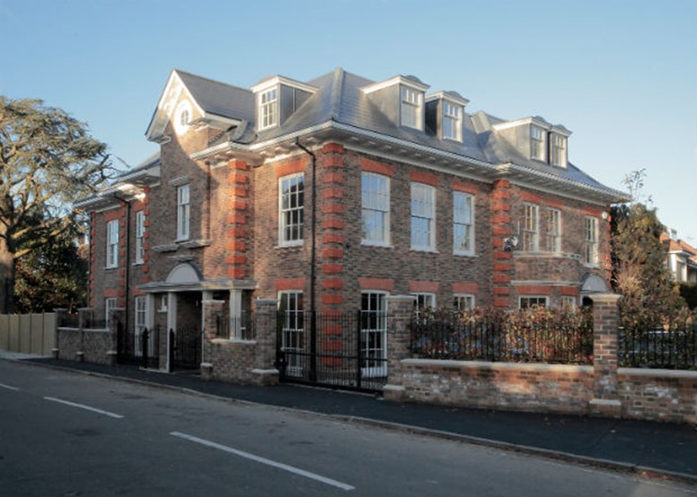 A modern mansion with elegant white timber sash windows