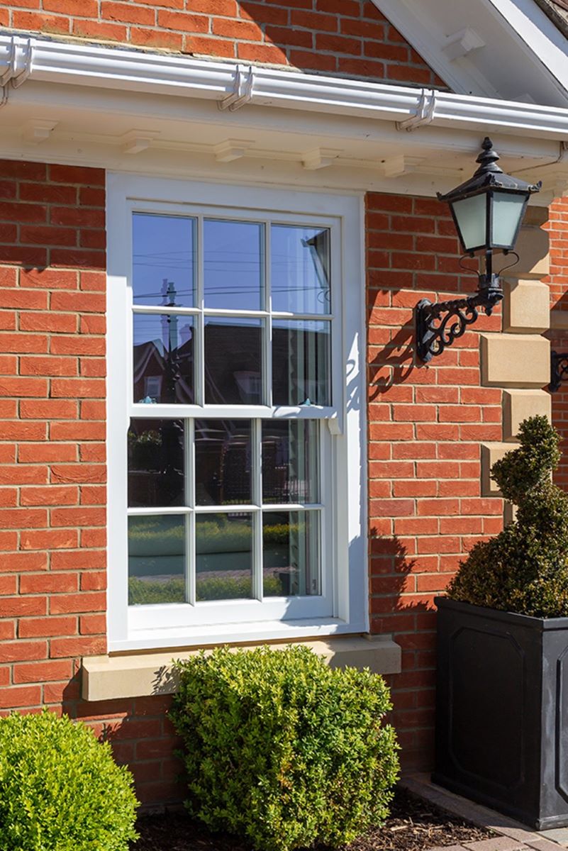 Wooden sash window outside of red brick house
