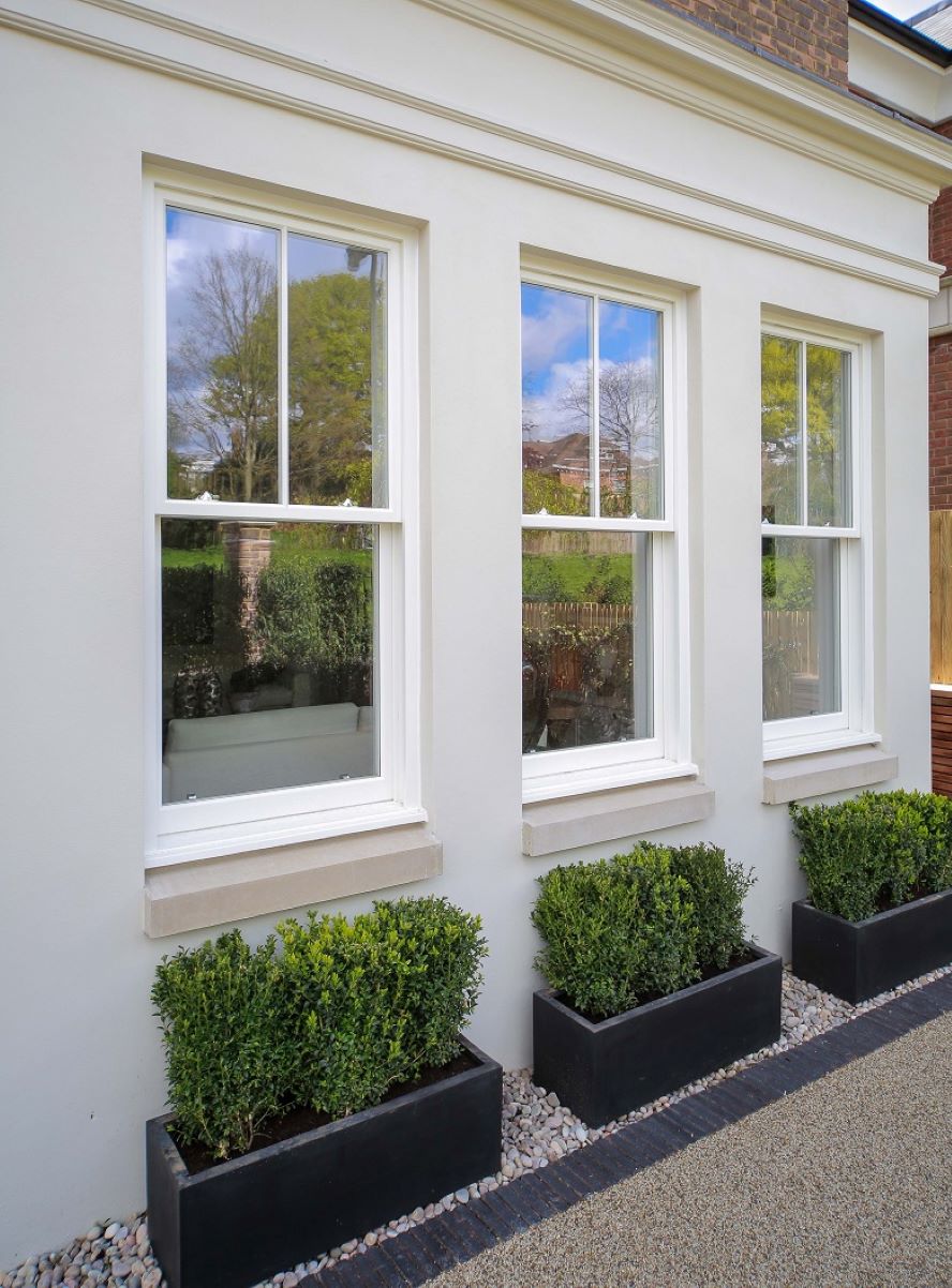 a trio of white timber sash windows