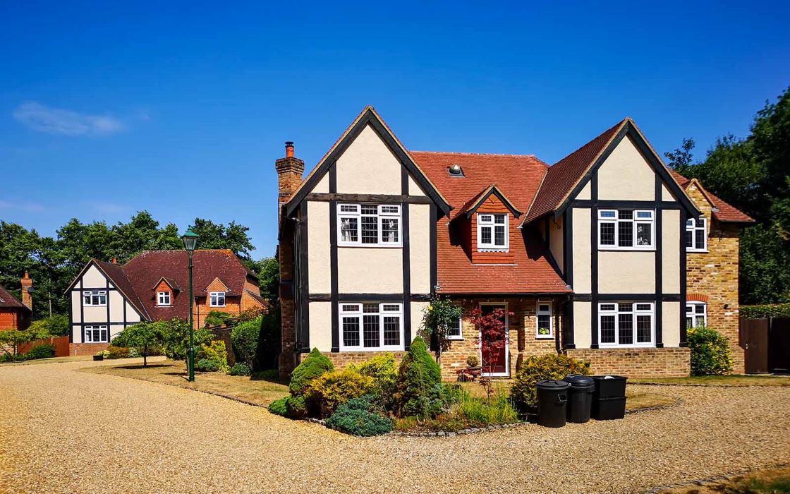 wide view of large cottage property with white timber windows